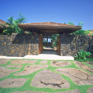 Photo of a mid-sized tropical front door in Hawaii with a double front door and a medium wood front door.