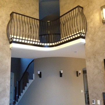 Interior Transitional Staircase with Wrought Iron Balusters