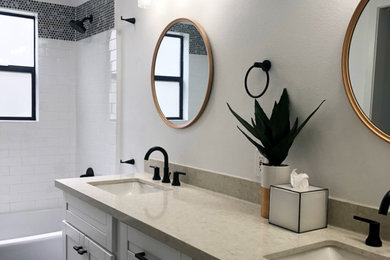 Example of a mid-sized transitional kids' white tile and ceramic tile ceramic tile and gray floor bathroom design in Houston with shaker cabinets, white cabinets, a one-piece toilet, white walls, an undermount sink, quartzite countertops and beige countertops