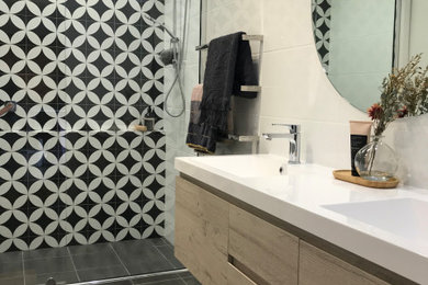 Mid-sized contemporary bathroom in Canberra - Queanbeyan with white tile, ceramic tile, ceramic floors, solid surface benchtops, white benchtops, a double vanity and a floating vanity.