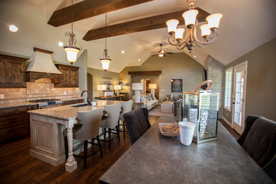 Inspiration for a mid-sized transitional l-shaped dark wood floor and brown floor open concept kitchen remodel in Other with a double-bowl sink, raised-panel cabinets, dark wood cabinets, granite countertops, beige backsplash, ceramic backsplash, stainless steel appliances and an island
