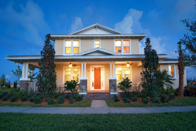 Inspiration for a mid-sized tropical two-storey beige exterior in Tampa with mixed siding.