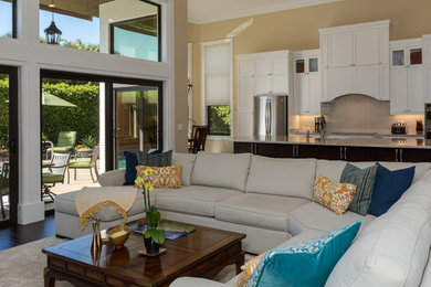 Large transitional open concept dark wood floor and brown floor living room photo in Miami with beige walls