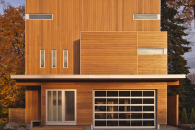 Example of a large minimalist three-story exterior home design in Ottawa