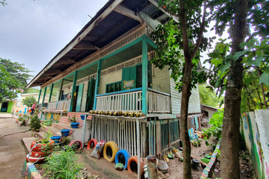 Island style home design photo in Other