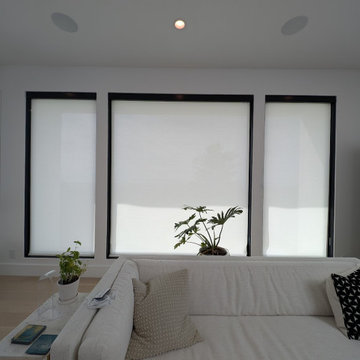 Inside Mount Motorized Solar Roller Shades under Black Metal Fascias.