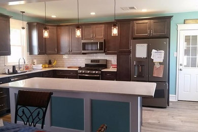 Eat-in kitchen - mid-sized transitional u-shaped vinyl floor and gray floor eat-in kitchen idea in Philadelphia with a drop-in sink, shaker cabinets, gray cabinets, quartzite countertops, white backsplash, ceramic backsplash, stainless steel appliances and an island