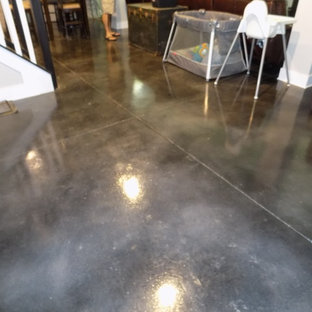 Photo of a large classic walk-out basement in Columbus with concrete flooring and black floors.