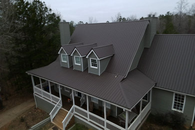 Inspiration for a large timeless green two-story concrete fiberboard and clapboard exterior home remodel in Atlanta with a metal roof and a brown roof