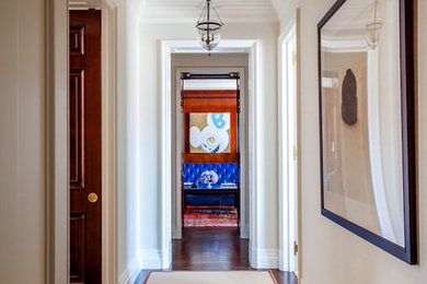 Example of a classic medium tone wood floor hallway design in New York with white walls