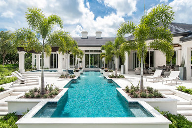 Inspiration for a mid-sized transitional backyard rectangular pool in Miami with natural stone pavers.