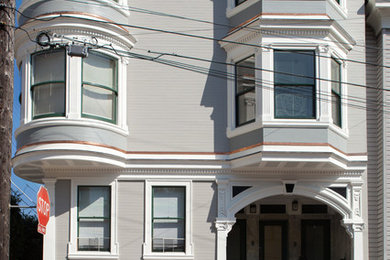 Large ornate gray three-story exterior home photo in San Francisco with a hip roof