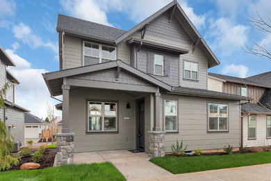 Inspiration for a mid-sized transitional green two-story concrete fiberboard gable roof remodel in Portland