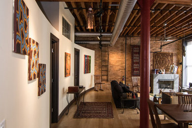 This is an example of a large eclectic hallway in Chicago with beige walls, medium hardwood floors and brown floor.