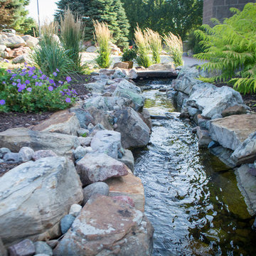 Rustic Mountain stream flowing into lakeside patio