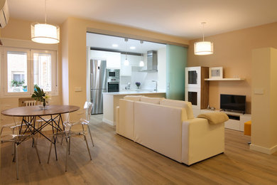 Inspiration for a mid-sized scandinavian medium tone wood floor great room remodel in Madrid with beige walls and no fireplace