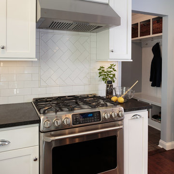 Stainless Steel Stove and Hood with Herringbone Backsplash