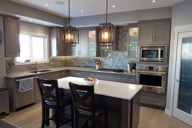 Photo of a mid-sized modern u-shaped eat-in kitchen in Edmonton with grey cabinets and with island.