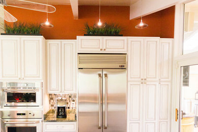 Inspiration for a mid-sized timeless l-shaped dark wood floor eat-in kitchen remodel in Baltimore with a double-bowl sink, raised-panel cabinets, white cabinets, stainless steel appliances and an island