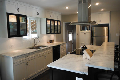 Elegant eat-in kitchen photo in Vancouver with shaker cabinets, white backsplash, subway tile backsplash and stainless steel appliances
