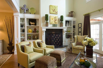 Mid-sized transitional open concept medium tone wood floor living room photo in Other with beige walls, a standard fireplace, a plaster fireplace and no tv