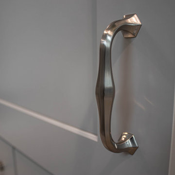 Waypoint Gray Shaker Door Cabinetry with Tiled Shower and Matching Tub Surround