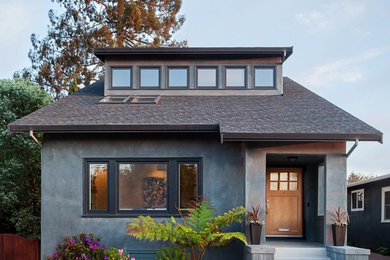This is an example of a transitional one-storey grey house exterior in San Francisco with a gable roof and a shingle roof.