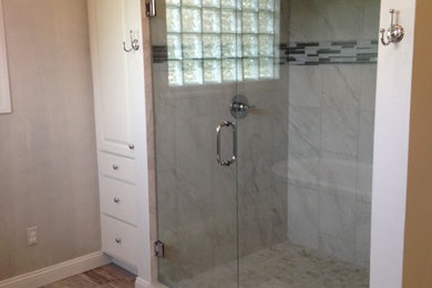 Alcove shower - large transitional master terra-cotta tile and multicolored tile terra-cotta tile alcove shower idea in Other with beige walls, raised-panel cabinets, white cabinets and a hinged shower door