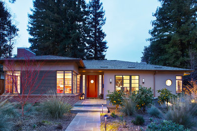 Mid-sized elegant beige one-story stucco house exterior photo in San Francisco with a hip roof and a shingle roof