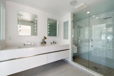 Mid-sized modern master bathroom in Los Angeles with flat-panel cabinets, white cabinets, an alcove shower, porcelain tile, white walls, porcelain floors, an undermount sink, quartzite benchtops, beige floor and a hinged shower door.