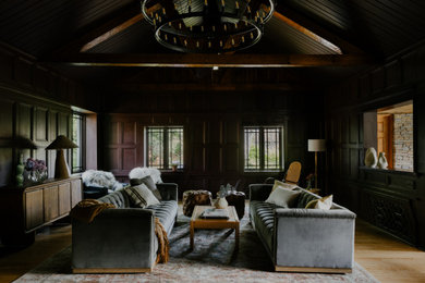 Inspiration for a large rustic enclosed light wood floor, vaulted ceiling and wall paneling living room remodel in New York with purple walls, a standard fireplace, a stone fireplace and no tv