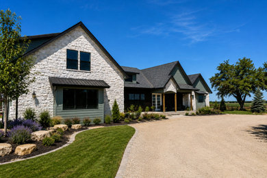 Large transitional green one-story mixed siding and board and batten exterior home photo in Boise with a mixed material roof and a black roof