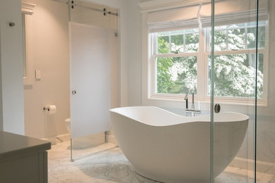 Example of an arts and crafts master marble floor and white floor freestanding bathtub design in Other with blue walls