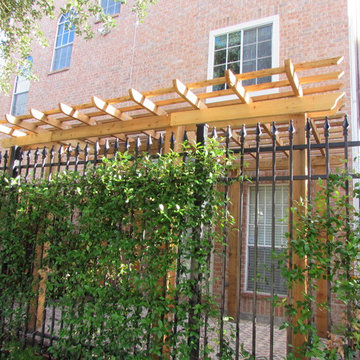 High function in a small side yard! Pergola, raised bed, mirrored wall, fountain