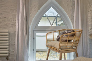 Design ideas for a large contemporary master bedroom in Devon with white walls, carpet and beige floors.