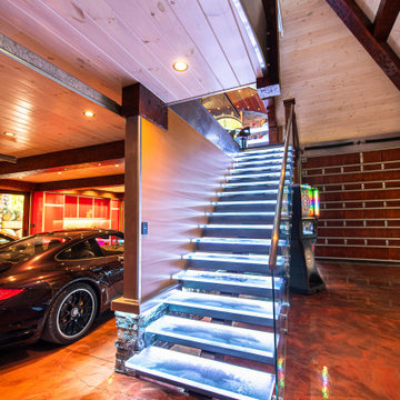 Glass private bar and glass stair treads inside a man cave in Michigan