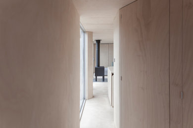 Scandinavian entry hall in Melbourne with plywood floors.