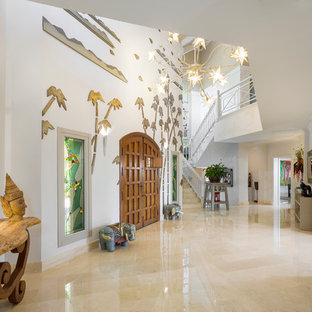 Inspiration for an expansive eclectic foyer in Other with white walls, a double front door and a medium wood front door.
