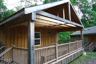Small rustic gray one-story wood exterior home idea in Other