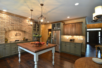 Eat-in kitchen - large traditional u-shaped dark wood floor eat-in kitchen idea in Detroit with raised-panel cabinets, green cabinets, beige backsplash, stainless steel appliances, a double-bowl sink, granite countertops, brick backsplash and no island