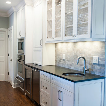 Wyite Cabinets with Chicken Wire Inserts and Granite Countertop