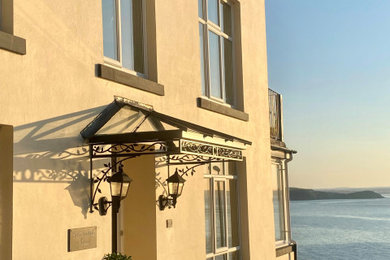 Inspiration for a medium sized beach style porch in Other with a single front door and a black front door.