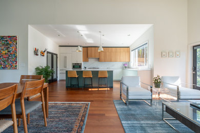 Inspiration for a large contemporary l-shaped open concept kitchen remodel in Seattle with flat-panel cabinets, white cabinets, quartz countertops, white backsplash, quartz backsplash, stainless steel appliances, an island and white countertops