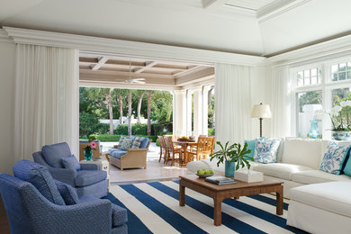 Beach style living room photo with white walls