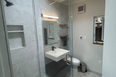 Example of a trendy single-sink corner shower design in San Francisco with a hinged shower door and a floating vanity