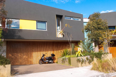 Inspiration for a contemporary two-storey exterior in Sydney with mixed siding.
