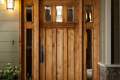 Traditional entryway in San Francisco with brown floor and a medium wood front door.