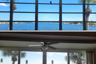 Inspiration for a large coastal three-story apartment exterior remodel in Tampa
