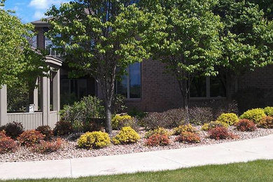 Design ideas for a traditional backyard stone landscaping in Other.