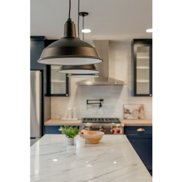 Industrial Matte Black Pendant Lighting over Navy Kitchen Island